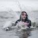 Richmond resident Abby Shaw from the Freezing Dead team jumps into Ford Lake for the Frozen Leap on Saturday, Feb. 16. Daniel Brenner I AnnArbor.com